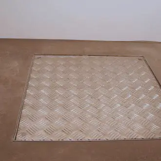 inspection-cover-installed-over-waback-rsd-uk Recessed lid covering inspection well for WaBack RSD in basement